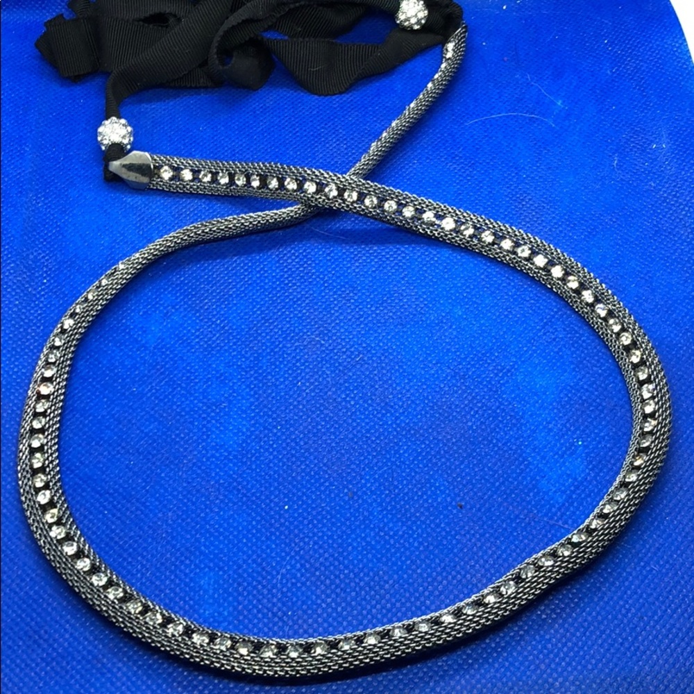 Silver necklace with clear stones.
